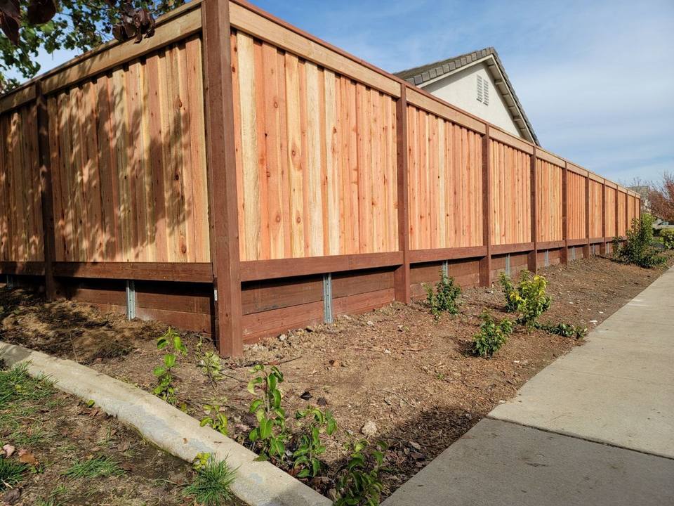 Redwood fence and gate at the corner of a house