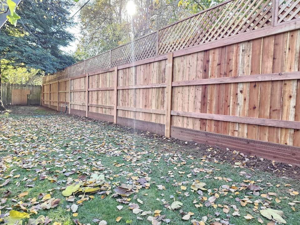 Redwood fence with a lattice top and a gate